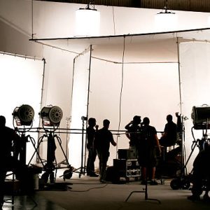 Silhouette of a production in progress on a white stage.