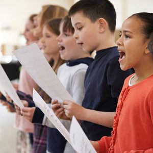 Group Of School Children Singing In Choir Together