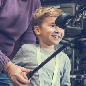 Boy With Grandfather Using Television Camera